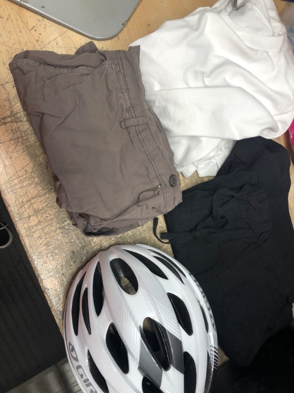 Photo 1 of ** MISCELLANEOUS BUNDLE***  4  ITEMS 
2 pack of mens shirts size 3xl, womens shorts size 34, bike helmet 
