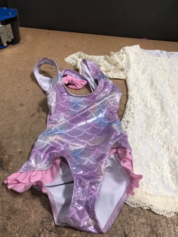 Photo 3 of Kids Apparel Bundle of 2 
White Dress (Size Not Printed) Pink/Purple Swimsuit Size 5  