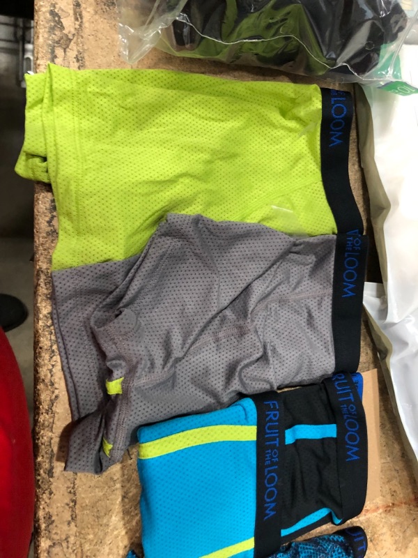 Photo 5 of bundle of boy and men clothes, sizes for underwears are small and medium and large  in kids, tank tops are size small(white), and large (black)