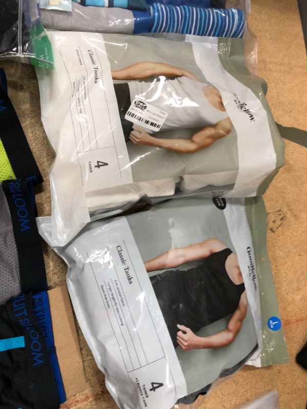 Photo 4 of bundle of boy and men clothes, sizes for underwears are small and medium and large  in kids, tank tops are size small(white), and large (black)