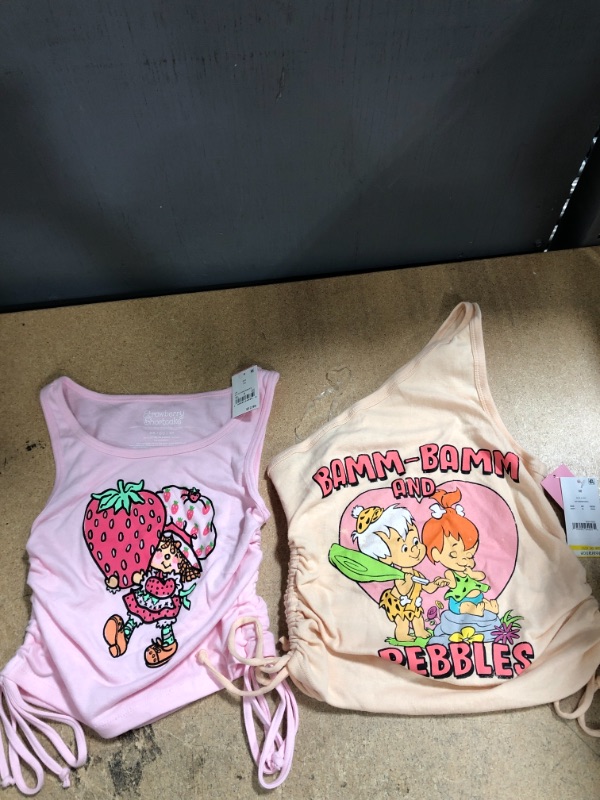 Photo 1 of 2 Sets of Women's Flintstones Pebbles and Bamm One Shoulder Graphic Tank Top Pink (Size M) & Strawberry Shortcake Cinched Graphic Tank Top (Size XS) 