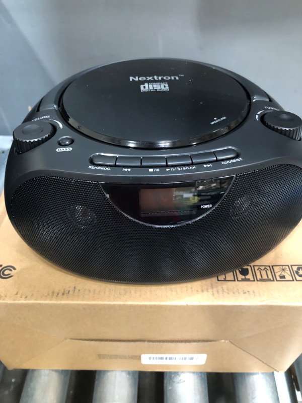 Photo 2 of Nextron Portable Bluetooth CD Player Boombox with AM/FM Radio Stereo Sound System, Playback CD/MP3/WMA, USB & AUX Ports, Headphone Jack, LCD Display, AC/DC Operated
