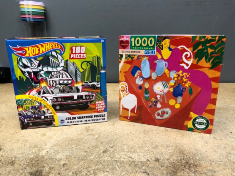 Photo 1 of bundle of 2 items 
Hot Wheels Color Surprise 100 Piece Magic Water Reveal Puzzle with Water Pen Included by TCG Toys, Multicolor and EeBoo Piece and Love: Eating Outside Jigsaw Puzzle - 1000pc

 