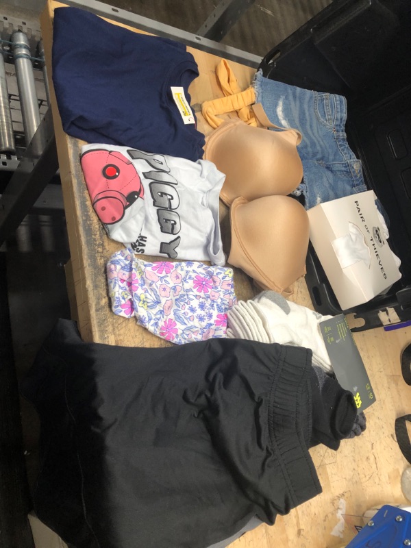 Photo 1 of **bundle of 9 clothing items, bra 34ddd, large shorts, medium girls jean shorts, shirts, size 4-10 socks 