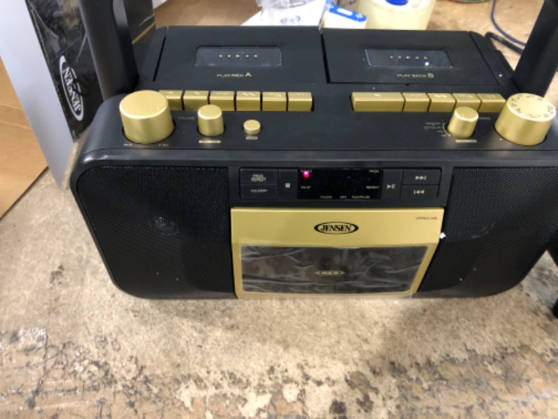 Photo 1 of Jensen MCR-1500 Gold Modern Retro Music System Portable CD/MP3 Cassette Player Stereo Boombox, LCD Display, Compact Dual Cassette Deck Recorder, AM/FM Radio, Bass Boost + Aux in & Headphone Jack
