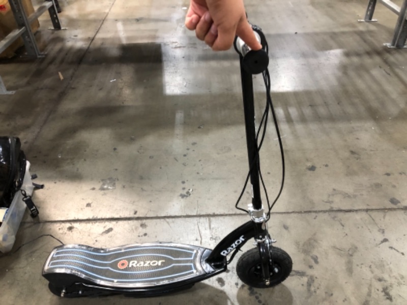 Photo 2 of **NONFUNCTIONAL**
ONLY TURNS ON WHILE PLUGGED IN AND CHARGING**
Razor E100 Electric Scooter