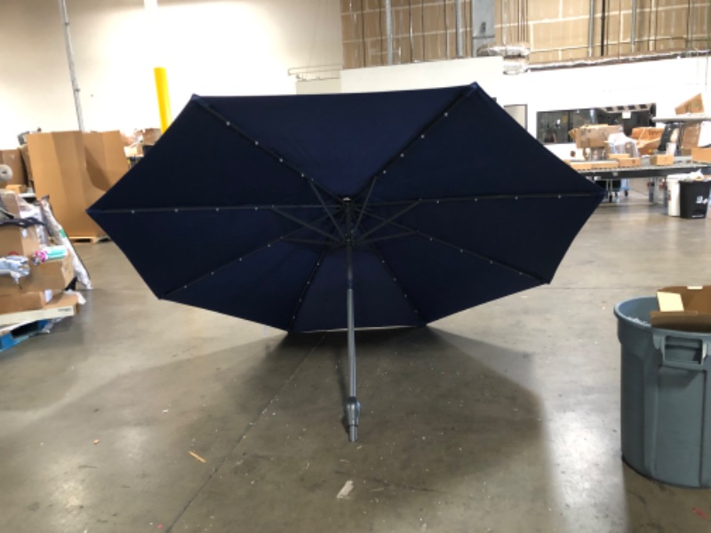 Photo 6 of (STAINED/TORN MATERIAL)10ft Solar Powered Aluminum Polyester LED Lighted Patio Umbrella w/Tilt Adjustment and UV-Resistant Fabric, Navy Blue