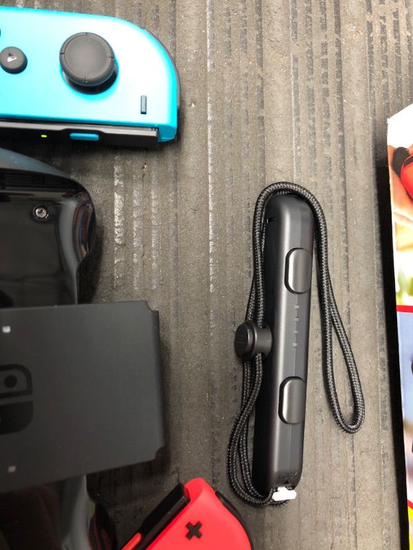 Photo 7 of Nintendo Switch with Neon Blue and Neon Red Joy-Con

