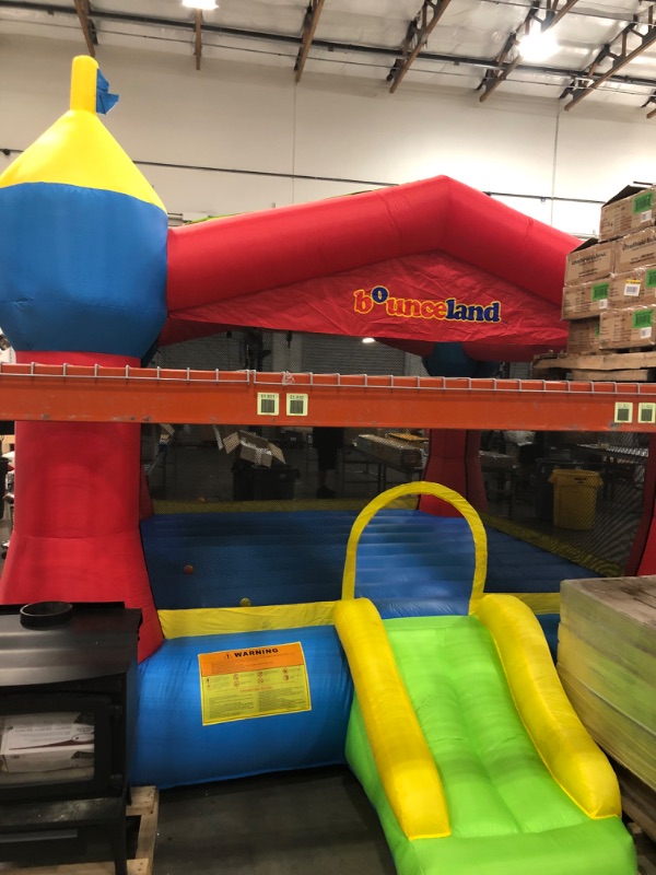 Photo 1 of Bounceland Inflatable Party Castle Bounce House Bouncer, 16 ft L x 13 ft W x 10.3 ft H, Basketball Hoop, Removable Sun Roof, UL Strong Blower included, Fun Slide and Bounce Area, Castle Theme for Kids
