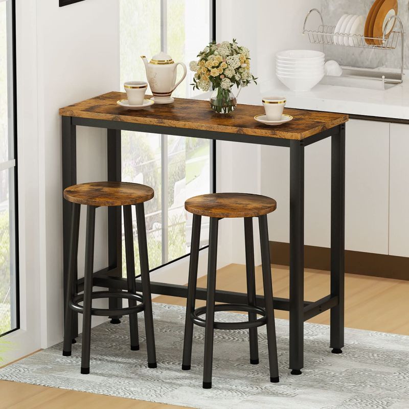 Photo 1 of AWQM 3 Piece Bar Table Set, 39.3" Pub Height Table with 2 Round Stools,Industrial Breakfast Bar Table Sets,Kitchen Table Set of 2 Ideal for Kitchen,Living Room,Bar,Rustic Brown
