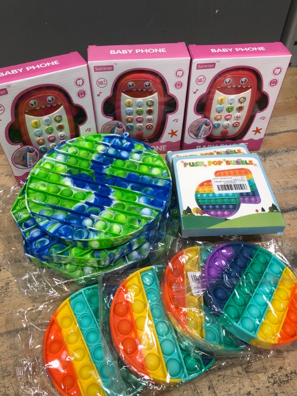 Photo 1 of **BUNDLE OF KIDS POP ITS/BABY SHARK PHONES**