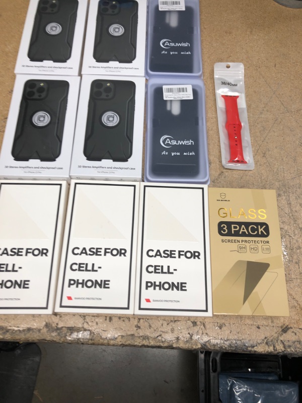 Photo 1 of Bundle of various cell phone cases, screen protectors, and a sport watch band