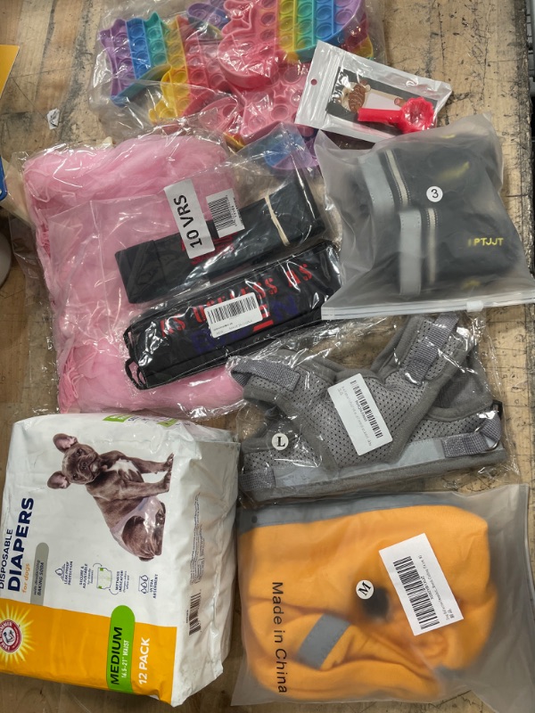 Photo 1 of **** BUNDLE BAG OF DOG ACCERORIES*** SOLD AS IS*** NO RETURNS*** NO REFUNDS***
**** Dog Adjustable Vest SIZE LARGE., DOG DIAPERS SIZE. MEDIUM, CLOTHES, AND OTHER ACCERORIES