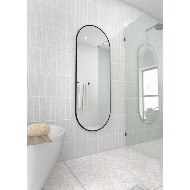 Photo 1 of 22 in. W x 60 in. H Stainless Steel Framed Pill Shape Bathroom Vanity Mirror in Black
