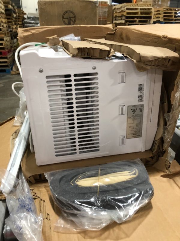 Photo 4 of Amazon Basics Window-Mounted Air Conditioner with Remote - Cools 250 Square Feet, 6000 BTU, Energy Star, Energy Star HEAVY USE UNABLE TO TEST SOME BENDING ON BACK VENT
