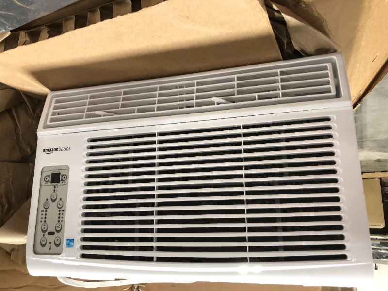 Photo 2 of Amazon Basics Window-Mounted Air Conditioner with Remote - Cools 250 Square Feet, 6000 BTU, Energy Star, Energy Star HEAVY USE UNABLE TO TEST SOME BENDING ON BACK VENT
