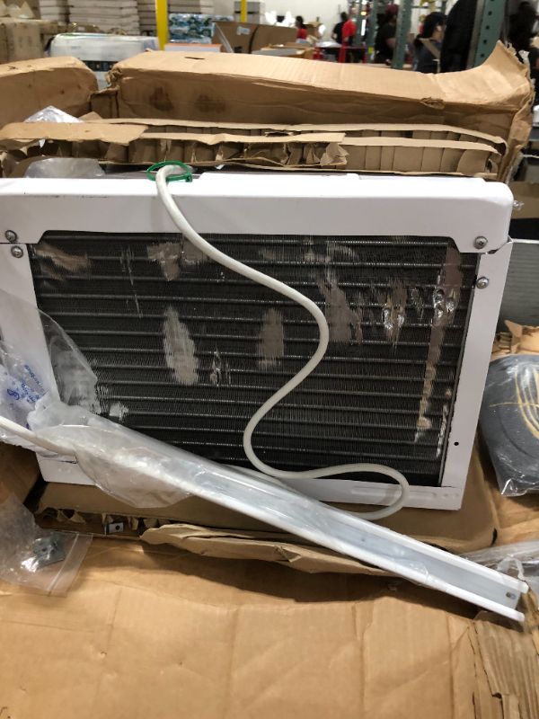 Photo 3 of Amazon Basics Window-Mounted Air Conditioner with Remote - Cools 250 Square Feet, 6000 BTU, Energy Star, Energy Star HEAVY USE UNABLE TO TEST SOME BENDING ON BACK VENT
