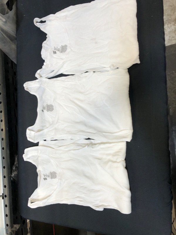 Photo 1 of bundle of 3 white tank tops 