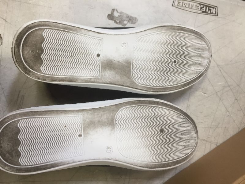 Photo 1 of BLACK AND WHITE SLIP-ON SHOES SIZE 9