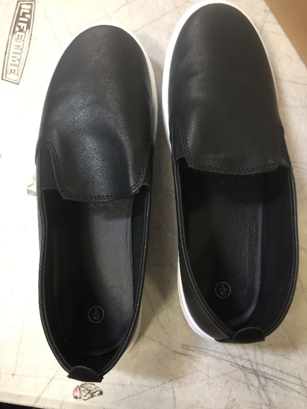 Photo 1 of BLACK AND WHITE SLIP-ON SHOES SIZE 9