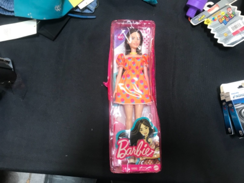 Photo 2 of Barbie Fashionistas Doll #160 with Long Brunette Hair Wearing Patterned Orange Dress, White Shoes & Yellow Choker, Toy for Kids 3 to 8 Years Old
