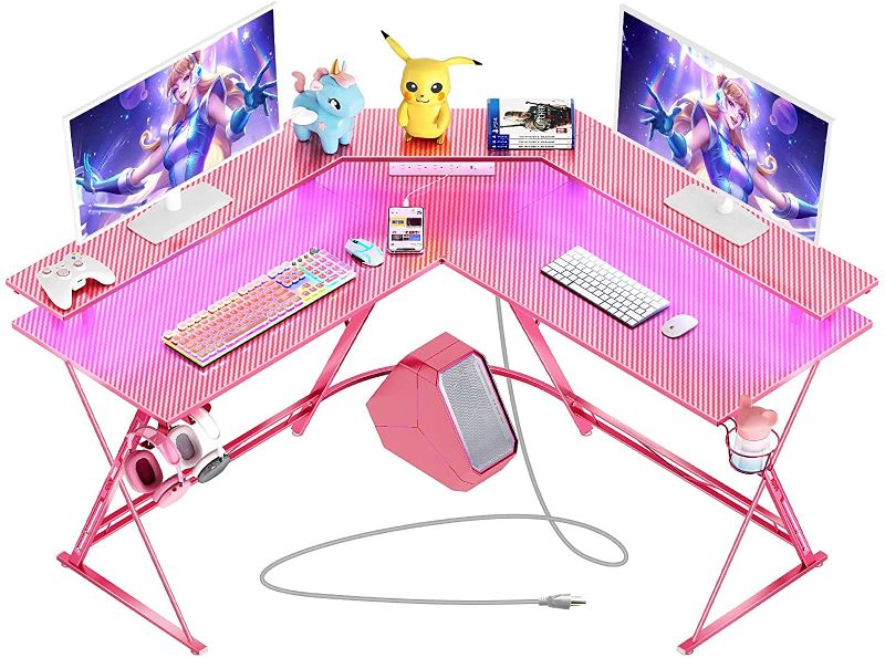 Photo 1 of SEVEN WARRIOR Gaming Desk 50.4” with LED Strip & Power Outlets, L-Shaped Computer Corner Desk Carbon Fiber Surface with Monitor Stand, Ergonomic Gamer Table with Cup Holder, Headphone Hook, Pink
