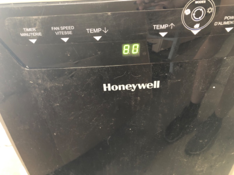 Photo 1 of Honeywell Classic Portable Air Conditioner with Dehumidifier & Fan Cools Rooms Up To 500 Sq. Ft. w Drain Pan & Insulation Tape, MN1CFS8 (Black/Silver)
