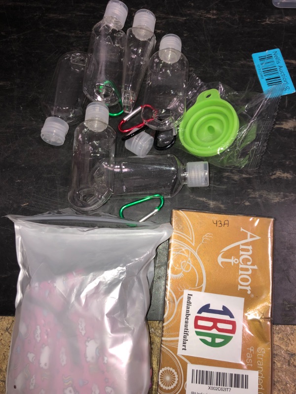 Photo 1 of Bundle of assorted bottles, anchor, and masks. (3 items)