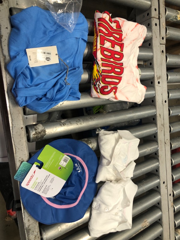 Photo 1 of CLOTHING BUNDLE 5 ITEMS:
BABY HAT
(2)XS UNIFORM TOPS
XL TANK TOP 
L CHAPARRAL SHIRT