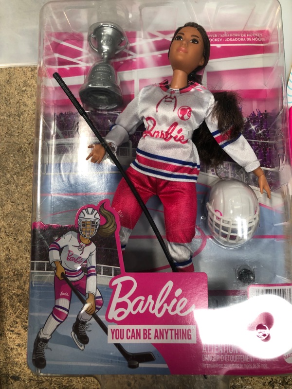 Photo 2 of Barbie Winter Sports Hockey Player Brunette Doll, Curvy Shape (12 in) with Jersey, Helmet, Hockey Stick, Puck & Trophy, 3 & Up
