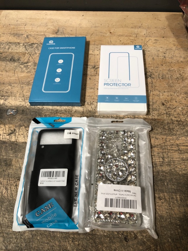 Photo 1 of BUNDLE OF 4 ASSORTED PHONE ITEMS---3 ASSORTED PHONE CASES AND 1 PK OF SCREEN PROTECTORS
UNKNOWN