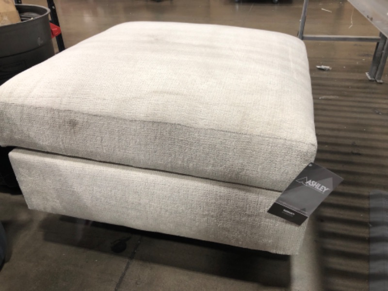 Photo 2 of *MINOR STAINS* Signature Design by Ashley Cambri Reversible Table Top Square Storage Ottoman with Cup Holders, White
