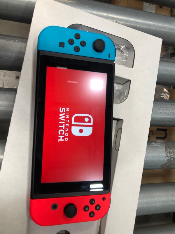 Photo 5 of Nintendo Switch with Neon Blue and Neon Red Joy-Con

