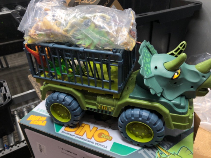 Photo 2 of Dinosaur Transport Truck Car with Dinosaur Toys for Kids 3-5 Boys Girls Birthday Gift Truck Toys Car with 15 Dino Figures Egg and Tree
