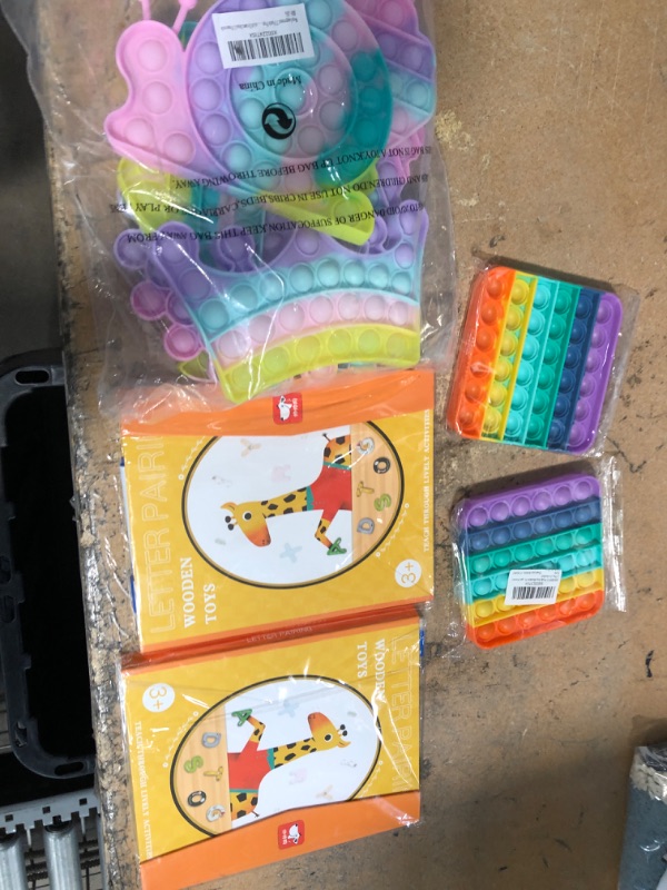 Photo 1 of BUNDLE OF FIDGET TOYS AND KIDS BOOKS.