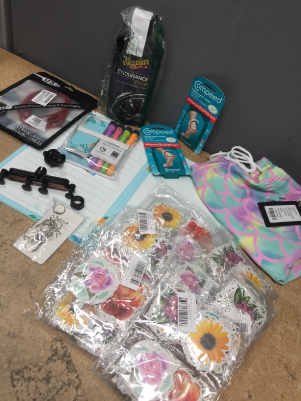 Photo 1 of *BUNDLE OF MIXED ITEMS-STICKERS/SWIM SHORTS SIZE M/TIRE GEL/PHONE HOLDER/RINGS/MARKERS/CHARGER/COMPEED BLISTER CARE*