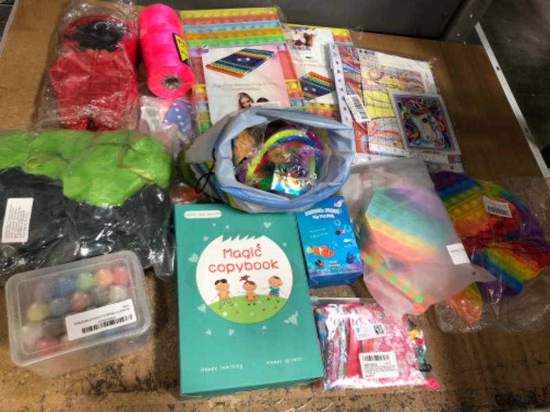 Photo 1 of assorted toy bundle- includes stufffed animals, ADHD pop it toys, sidewalk chalk- 12 items 