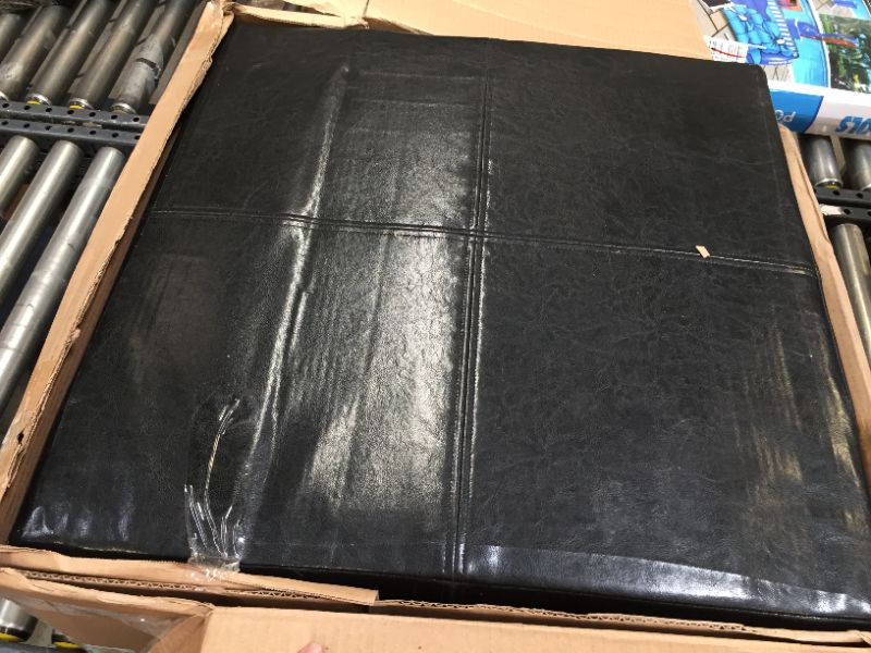 Photo 1 of BLACK FAUX OTTOMAN - 27"X27" - 11" HEIGHT---ITEM IS DIRTY/HAS TAPE RESIUDE---ITEM HAS BLADE SCRTAHCES---