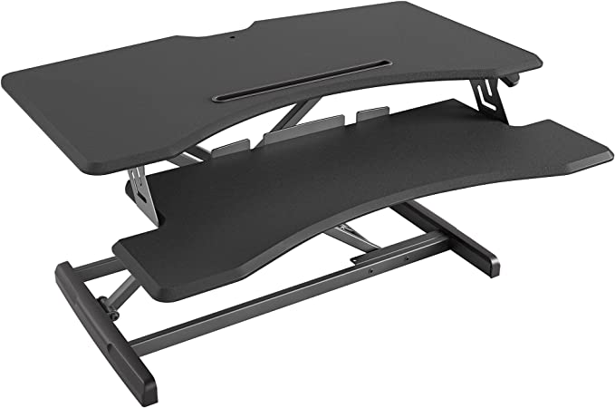 Photo 1 of FEZIBO Standing Desk Converter Stand up Desk Riser, 34 inches Height Adjustable Ergonomic Tabletop Workstation Riser Fits Dual Monitors Black
