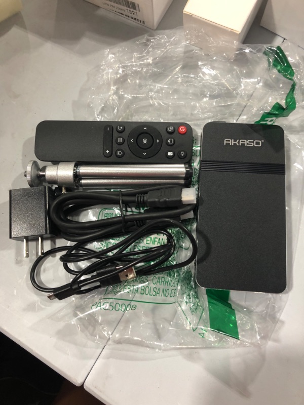 Photo 1 of AKASO Mini Projector, Pocket-Sized DLP Portable Projector, 1080P Cookie Projector , Support HDMI WiFi Built-in Rechargeable Battery Stereo Speakers and Remote Control Movie Projector
