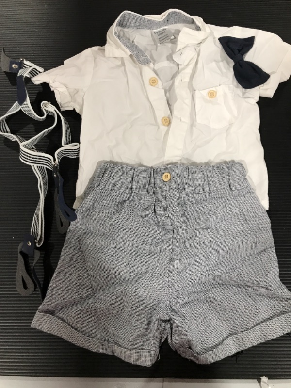 Photo 1 of A baby 69 months white buttoned up onesie with blue patterned short as well as suspenders and a bow tie. 