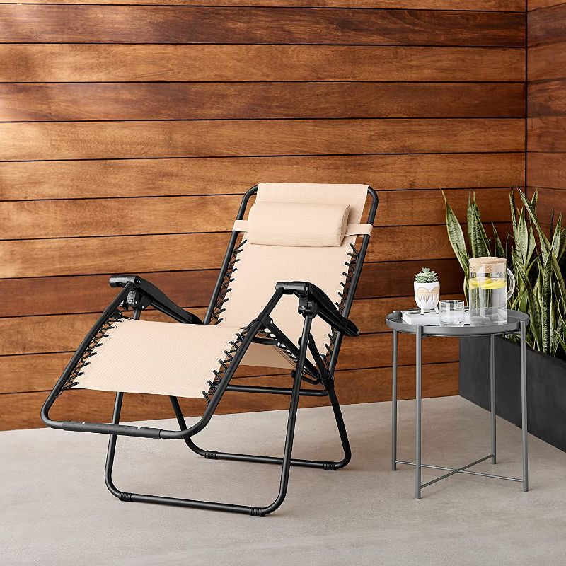 Photo 1 of Amazon Basics Outdoor Textilene Adjustable Zero Gravity Folding Reclining Lounge Chair with Pillow, Beige
