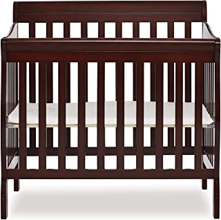 Photo 1 of Dream On Me Aden 4-in-1 Convertible Mini Crib in Espresso, Greenguard Gold Certified. Box packaging Damaged, Wood Chipped in Places, Shown in Pictures. 
