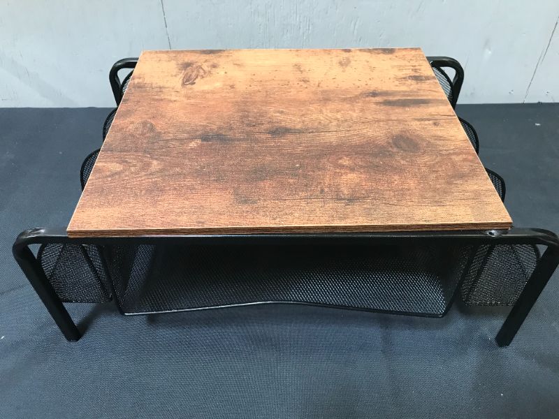 Photo 1 of BLACK METAL STAND WITH SIDE HOLDERS AND WOODEN TOP. ITEM IS DAMAGED, DENT TO METAL AND MISSING SCREWS TO WOODEN TOP