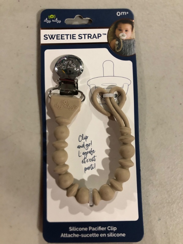 Photo 1 of Itzy Ritzy Silicone Pacifier Clip; 100% Silicone Pacifier Strap with Clip Keeps Pacifiers, Teethers & Small Toys in Place; Features One-Piece Design & Silicone Cord, Toast