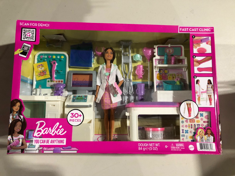 Photo 2 of Barbie Fast Cast Clinic Playset, Brunette Doctor Doll (12-in), 30+ Pieces, 4 Play Areas, Cast & Bandage Making, Medical & X-ray Stations, Exam Table, Gift Shop & More, 