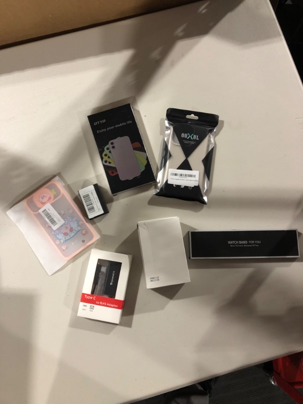 Photo 1 of Electronics Bundle- Phone cases, adapter cable, watch band, charger cable, batteries