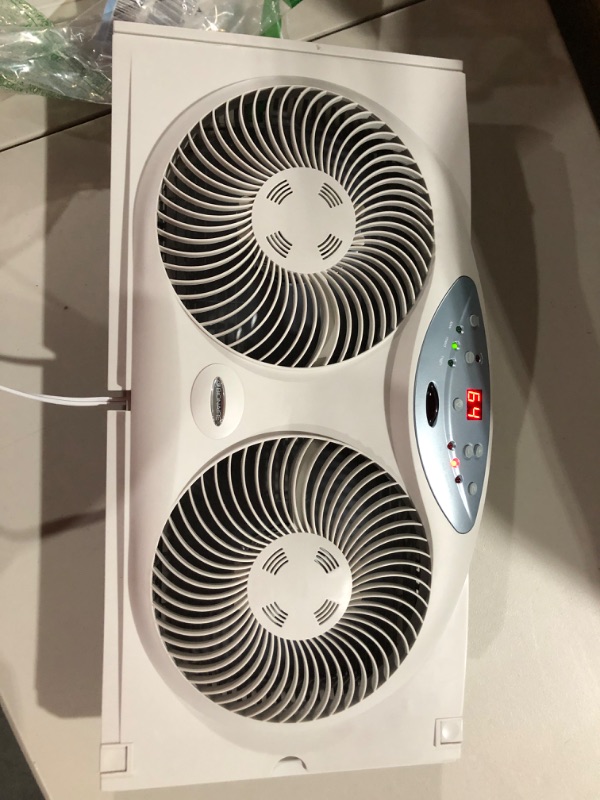 Photo 2 of Bionaire Window Fan with Twin 8.5-Inch Reversible Airflow Blades and Remote Control, White White 2 Blades Electronic control with LCD screen Window Fan