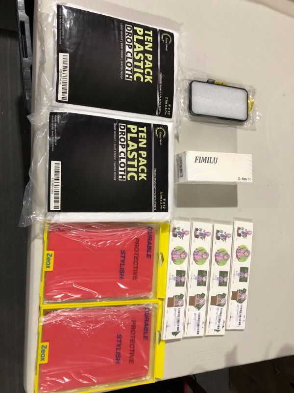 Photo 1 of (2) 10Pck plastic drop clothes, (2)slim protective iPad case, (4)Pck grade-schooler stickers, iPhone 11 case.