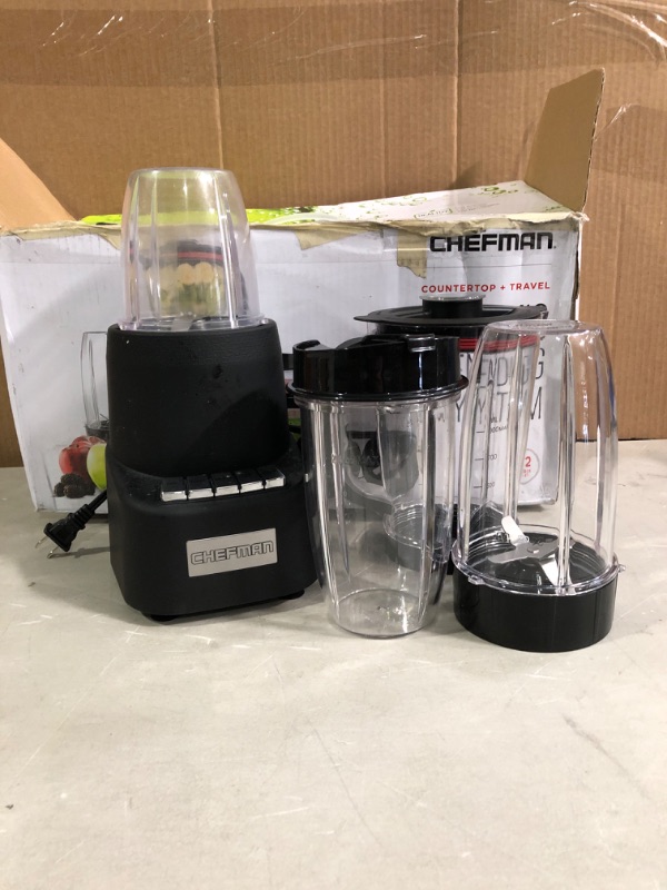 Photo 2 of Chefman Countertop + Travel Dynamic Blending System, Dishwasher-Safe 
* Used, base and 1 tumbler * Other 3 cups appear unused. * Unit powers up *